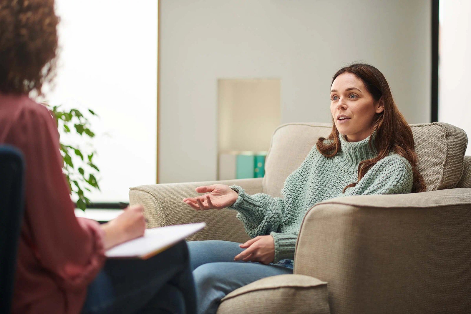 A woman in conversation with a clinician during a consultation