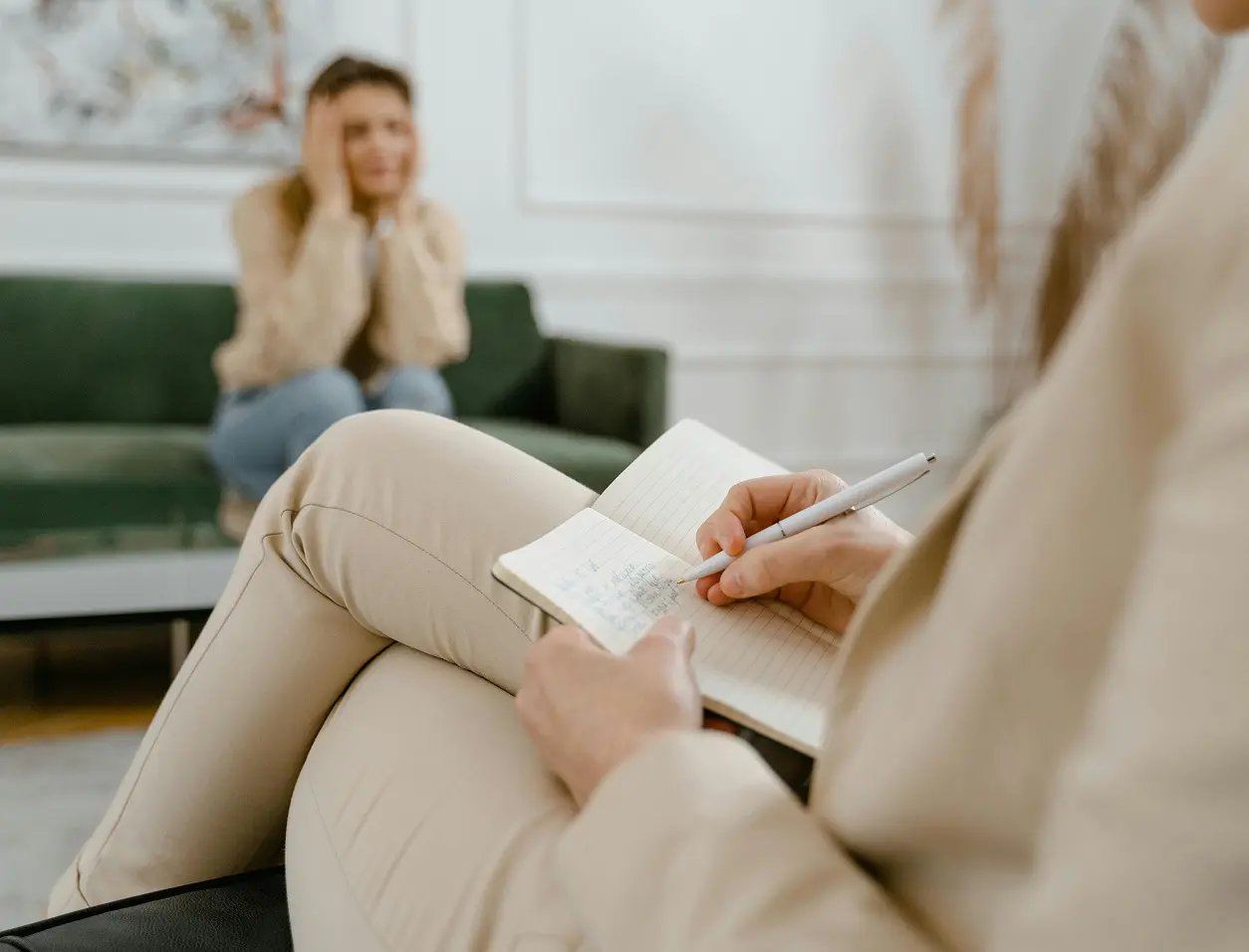 A person writing notes during an appointment